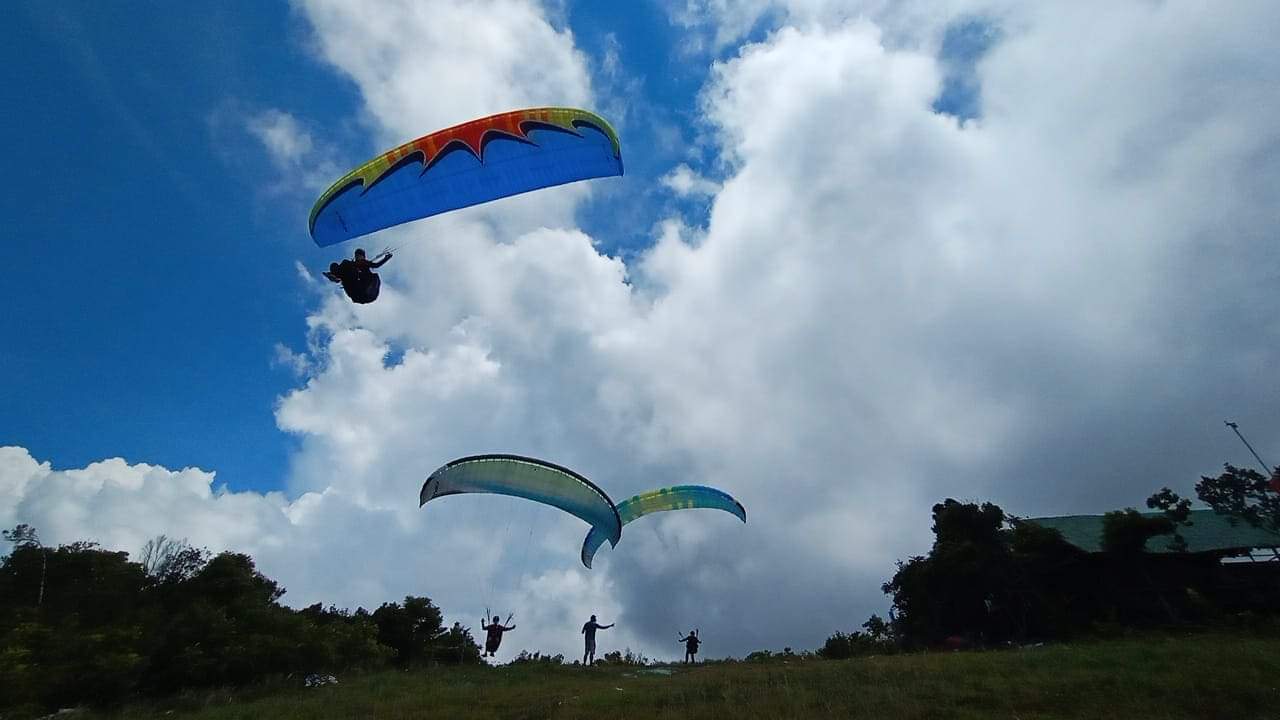 Tandem paragliding flight over Oslob Cebu mountains and coastline